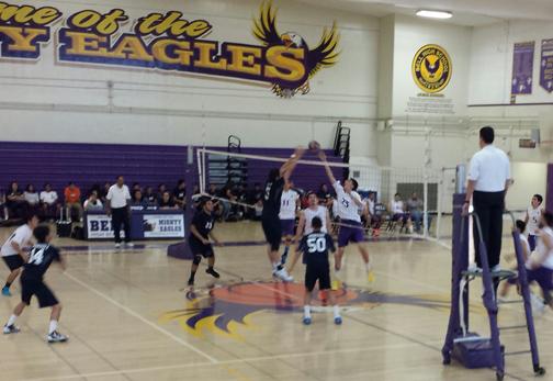 Bell High School’s Number 23 tips the ball over the net and over players of the opposing team. 