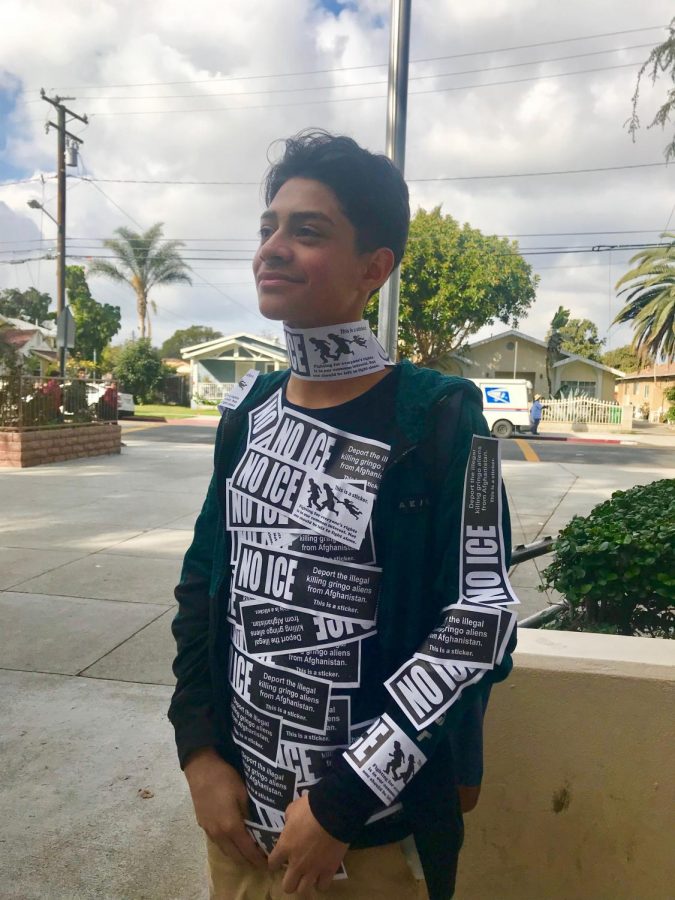 Jason Romero, a freshman in Alpha wears a full torso of "No ICE" stickers from Jack.